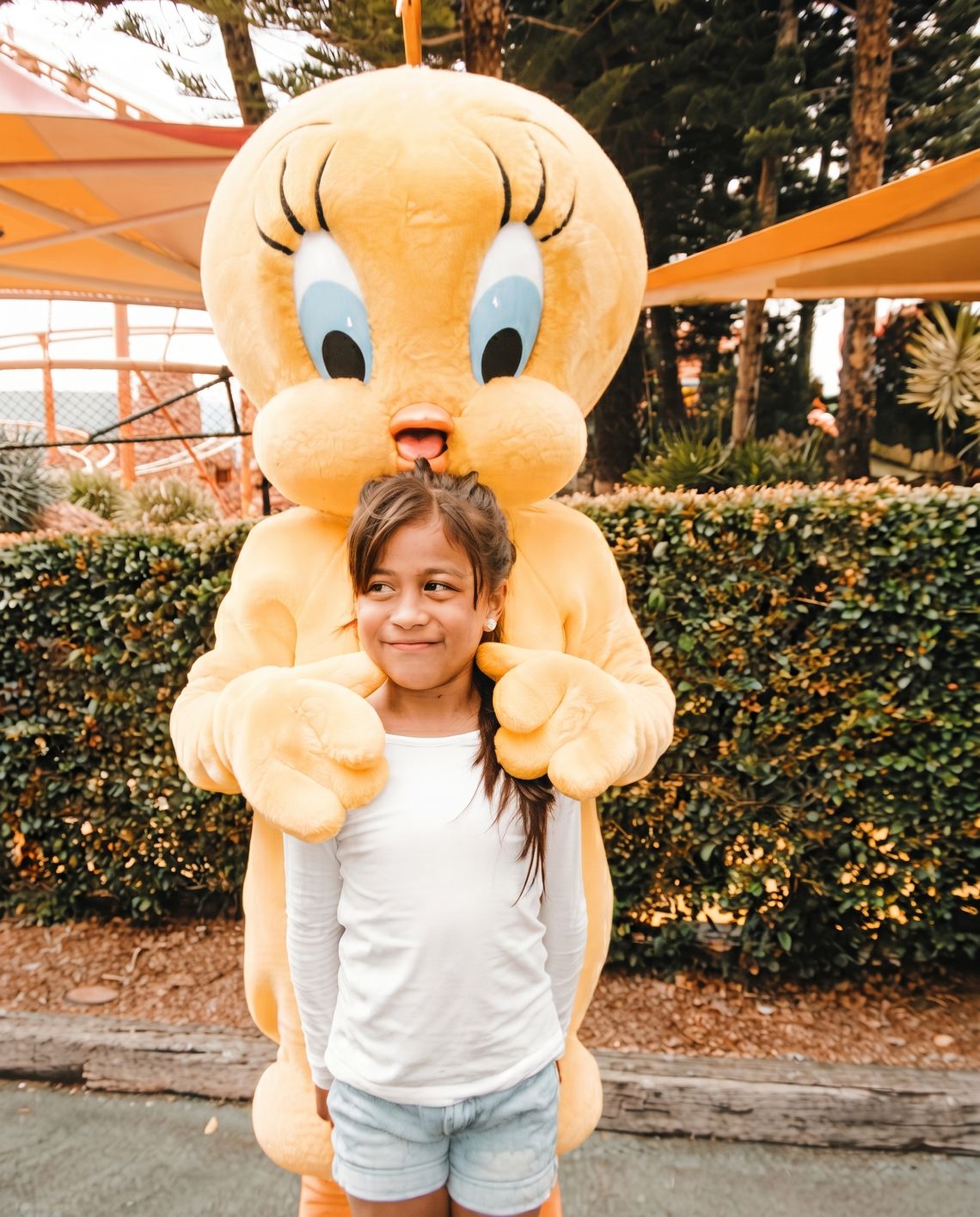 Angels as a child, smiling with a Tweety Bird mascot